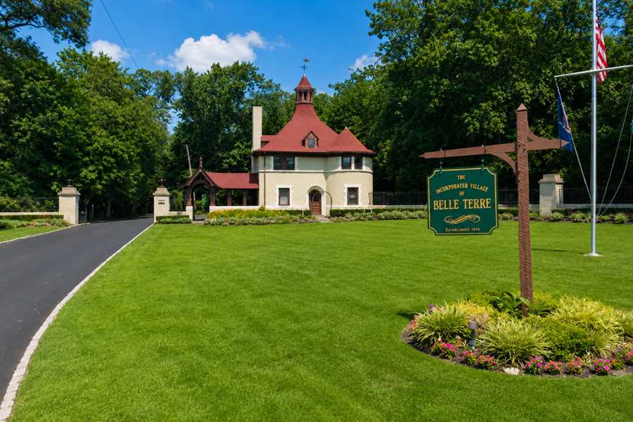 Entrance to the Village of Belle Terre, where a distinctive historic gatehouse, manicured grounds, and tree-lined setting create one of Long Island's most recognizable community entrances.