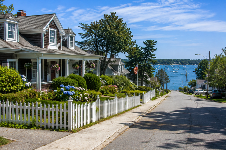 A quiet residential street in Greenport West, New York, gently slopes toward the waterfront, where Peconic Bay provides a scenic backdrop to this peaceful North Fork community. With its charming homes, mature landscaping, and close proximity to Greenport's marinas, restaurants, ferry terminal, and historic downtown, Greenport West offers a relaxed coastal lifestyle just minutes from one of Long Island's most beloved seaside villages.