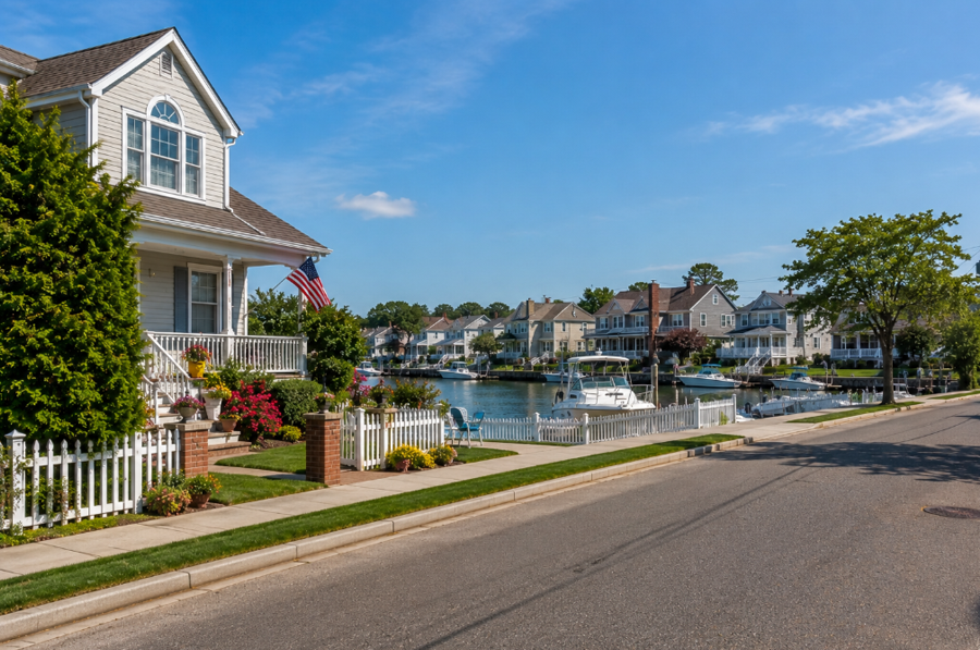 Waterfront homes and private docks line a quiet canal in Harbor Isle, New York, highlighting the community's close connection to boating and life along Reynolds Channel. This peaceful South Shore neighborhood combines scenic coastal surroundings with convenient access to nearby beaches, marinas, parks, and the Long Island Rail Road.