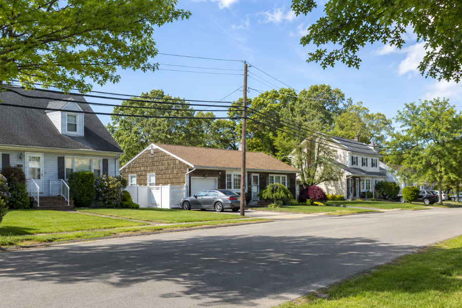 A tree-lined residential neighborhood representative of Terryville, New York, in the Town of Brookhaven. The community features established suburban streets, detached single-family homes, mature landscaping, and a quiet residential setting.
