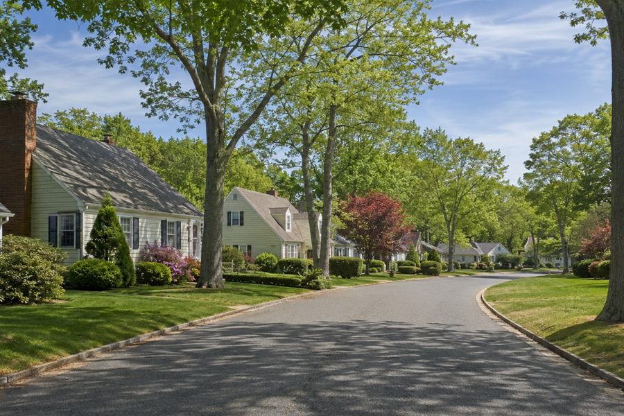 A tree-lined residential street representative of Village of the Branch, New York, in the Town of Smithtown. Traditional homes, mature landscaping, and quiet surroundings reflect the established suburban character of this small incorporated village.