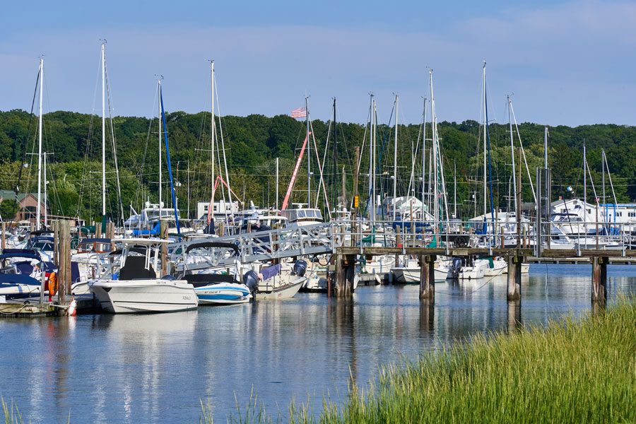 A marina along Huntington Harbor in Halesite, New York, showcases dozens of recreational boats docked in one of Long Island's most active boating communities. Protected waters, modern marina facilities, and easy access to Long Island Sound have made Halesite a popular destination for sailing, fishing, and waterfront recreation on the North Shore.