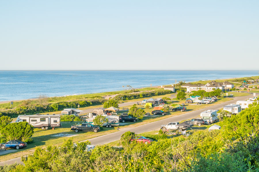 Campers enjoy oceanfront campsites at Hither Hills State Park in Montauk, one of the few places on Long Island where visitors can camp just steps from the Atlantic Ocean. From beachfront camping to wooded campgrounds and family-friendly RV sites, Long Island offers a variety of scenic camping experiences for outdoor enthusiasts. File photo: Elzbieta Sekowska, licensed.