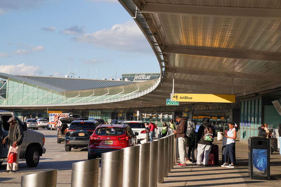 Passengers arrive and depart outside John F. Kennedy International Airport (JFK), one of the nation's busiest aviation hubs and a primary gateway for travelers visiting Long Island, New York City, and destinations throughout the Northeast. File photo: Leonard Zhukovsky, licensed.