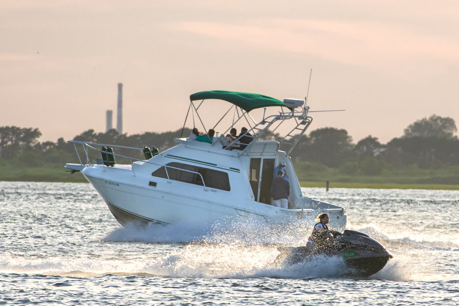 Boaters and personal watercraft travel through the waters near Jones Inlet alongside Jones Beach State Park. The inlet serves as one of Long Island's busiest gateways between the Atlantic Ocean and Great South Bay, supporting recreational boating, fishing, and marine navigation throughout the year. File photo: Scott Heaney, licensed.