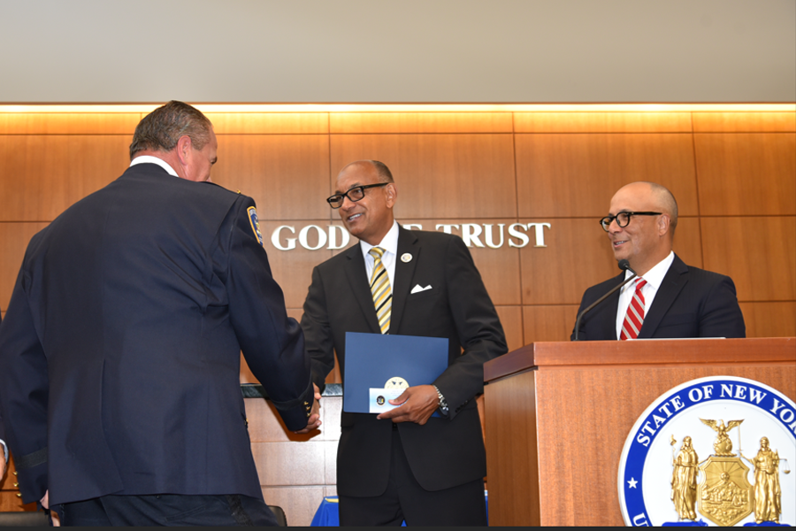 Lieutenant Richard Hilary is congratulated by First Deputy Chief Administrative Judge Norman St. George for his more than 30 years of service to the court while Presiding Justice of the Appellate Division for the 2nd Department Hector LaSalle looks on.