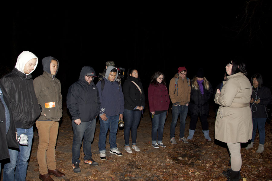 Participants gather along Mount Misery Road in West Hills during a guided paranormal investigation, reflecting the roadway's long-standing reputation as one of Long Island's most famous locations for ghost stories and urban legends. While the road has inspired generations of local folklore, it remains a public roadway surrounded by the scenic woodlands of West Hills County Park. File photo: Eddtoro, licensed.
