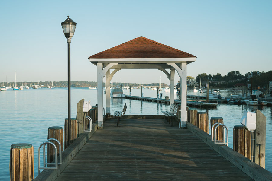 A covered pier extends into Northport Harbor, offering scenic views of one of the North Shore's most picturesque waterfronts. Surrounded by marinas, sailboats, and the calm waters leading to Long Island Sound, Northport Harbor serves as a popular destination for boating, fishing, waterfront walks, and enjoying the maritime character of the historic Village of Northport. File photo: Jon Bilous, licensed.
