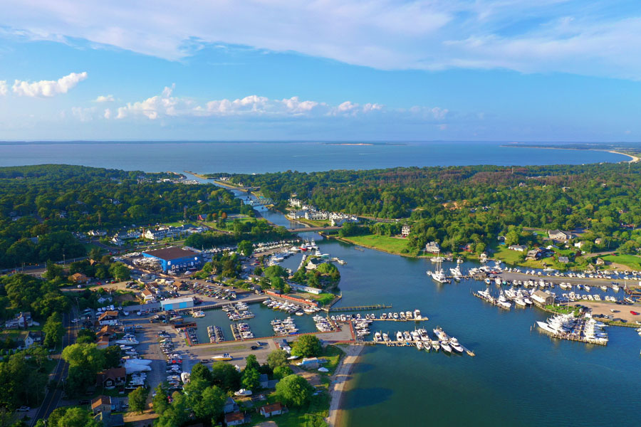 An aerial view of the Shinnecock Canal in Hampton Bays, New York, shows the canal linking Shinnecock Bay with Great Peconic Bay. The canal serves as one of Long Island's most important navigational waterways, supporting recreational boating, commercial fishing, and marine traffic throughout the East End. File photo: Hamptons UAV, licensed.