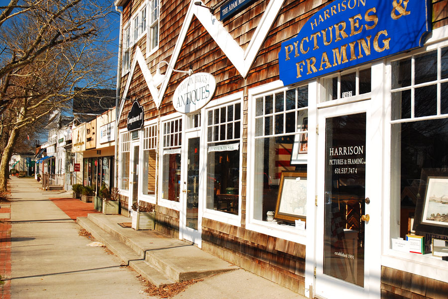 Historic storefronts line Main Street in East Hampton, one of Long Island's premier shopping destinations, during the quiet winter season. The village's boutiques, art galleries, antique shops, and specialty retailers attract thousands of visitors each summer, offering a very different atmosphere from the peaceful streets seen here in early March.