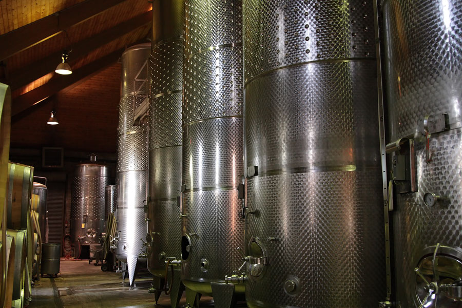 Large stainless-steel fermentation tanks inside a Long Island winery are used during the winemaking process. Modern wineries throughout North Fork Wine Country combine traditional vineyard practices with contemporary production techniques to create a wide range of red, white, rosé, sparkling, and dessert wines.