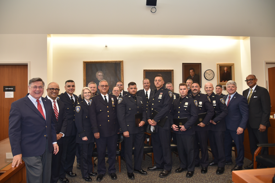 The court officer honorees stand with administrators and local officials