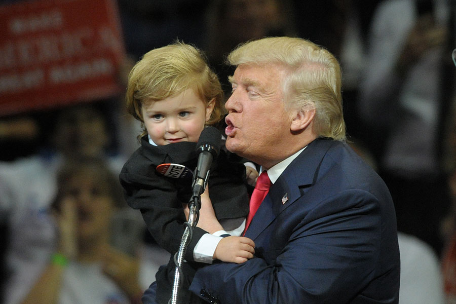 President Donald Trump holds a young supporter during a campaign rally in Wilkes-Barre, Pennsylvania, in 2016. The new federal Trump Accounts program provides eligible children born between 2025 and 2028 with a one-time $1,000 investment from the U.S. Treasury.
