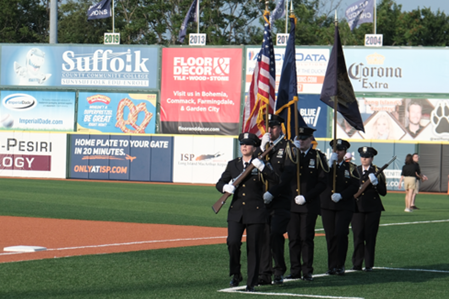The UCS Court Officer Ceremonial Color Guard marches onto the field to present the Colors.