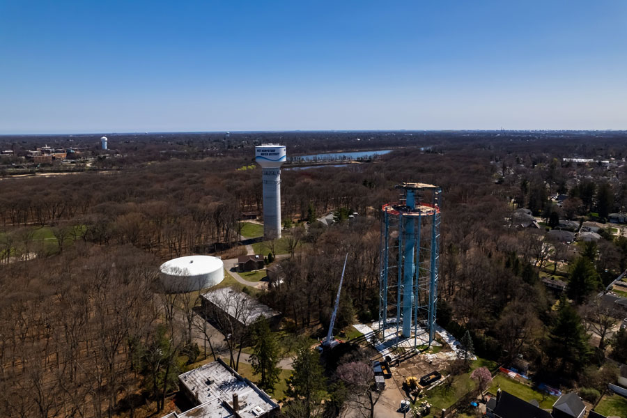 An aerial view shows the West Hempstead Water District during the demolition and replacement of its aging water tower, with Hempstead Lake State Park visible in the distance. The infrastructure project modernized one of the community's most recognizable landmarks while maintaining reliable water service for local residents. File photo: Wirestock Creators, licensed.