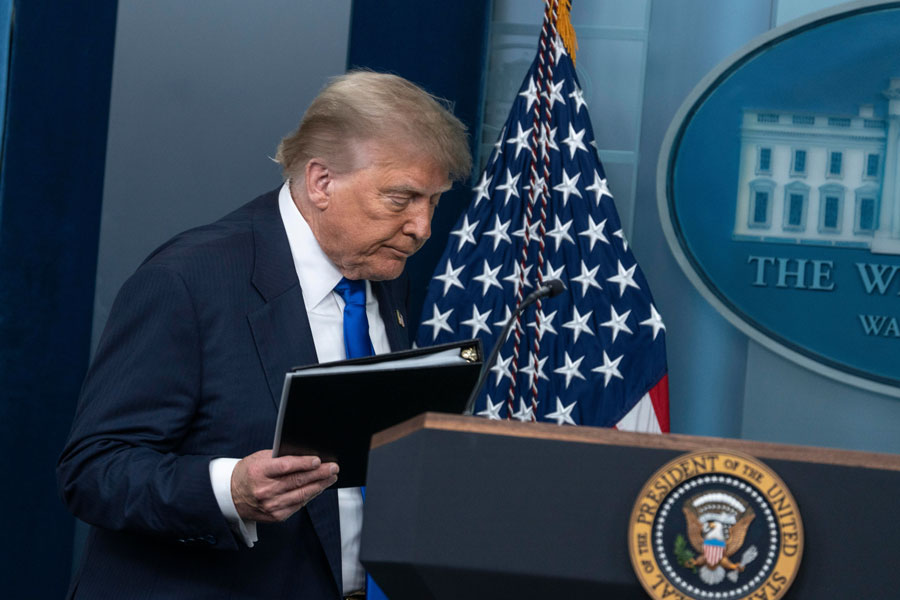 President Donald Trump arrives at the podium during a White House address outlining newly declassified intelligence concerning election security, foreign interference, voter data, and alleged fraud investigations. The administration says the release raises new questions about information that was withheld from the public and previous officials.