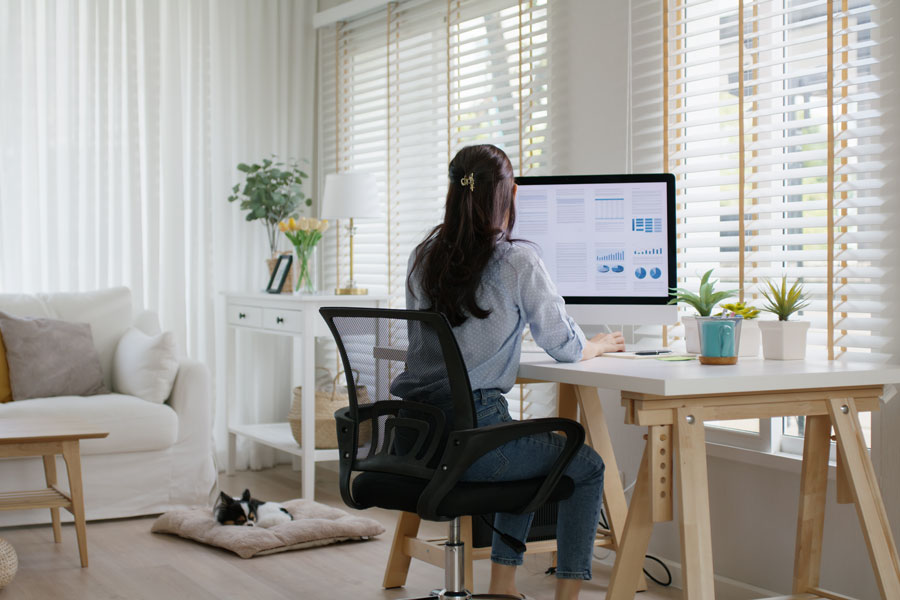 Person working from home at a desk in a home office.