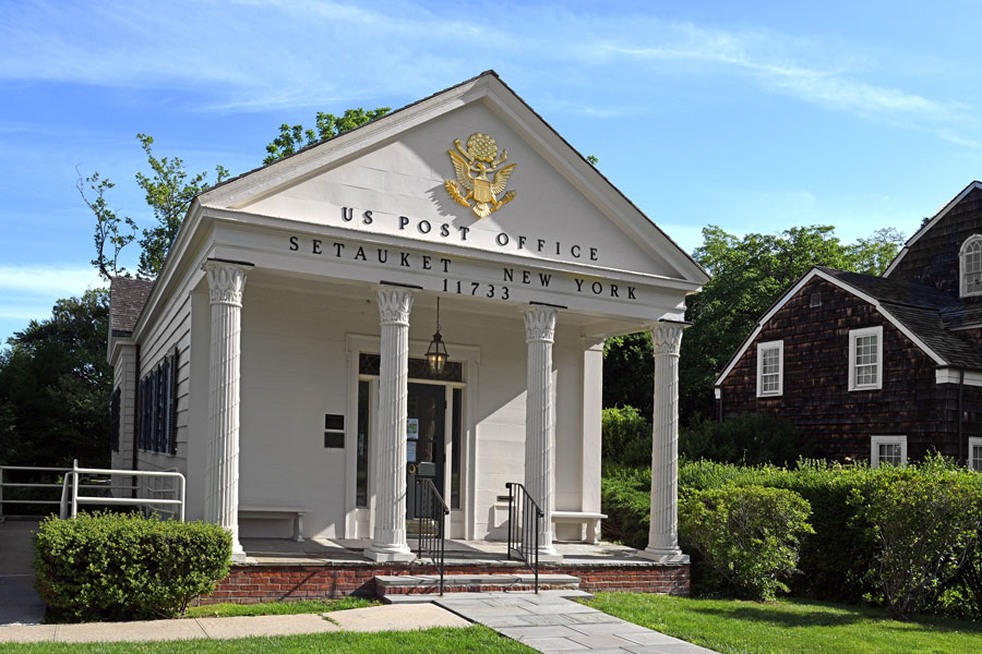 The historic Setauket Post Office prominently displays ZIP code 11733 above its entrance in Setauket, New York. The image illustrates how ZIP codes serve as postal identifiers for communities across Long Island. Although ZIP codes were created for mail delivery, they are also commonly used to identify local areas and organize geographic information.