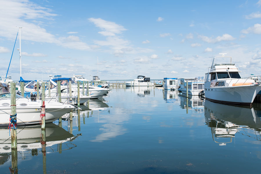 Boats are docked at a Long Island marina, reflecting the island's rich boating culture and extensive waterfront. With hundreds of marinas, public launches, and rental facilities along the Atlantic Ocean, Long Island Sound, bays, and harbors, Long Island is one of the premier boating destinations in the Northeast. File photo: Michael Moloney, licensed.
