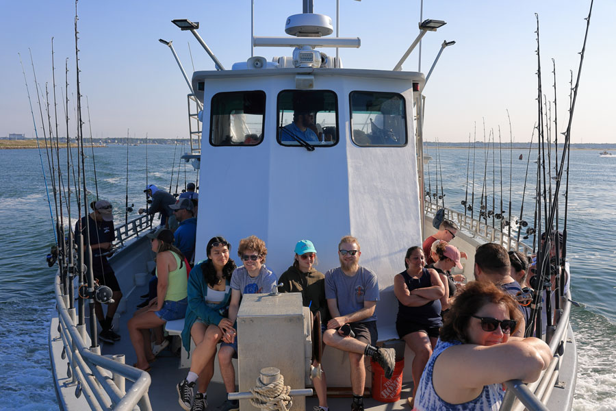 Passengers enjoy a day aboard a Long Island fishing charter, where experienced captains guide anglers to some of the region's best fishing grounds. Charter boats depart from ports across the island and offer trips for beginners, families, and seasoned fishermen targeting a variety of inshore and offshore species. File photo: Hike Kayak Fish, licensed.