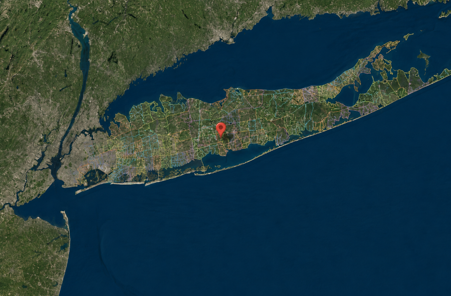 A satellite view of Long Island illustrates the complex network of communities and jurisdictional boundaries spanning Nassau and Suffolk counties. The location marker represents how a single address can be connected to multiple municipal and service districts.
