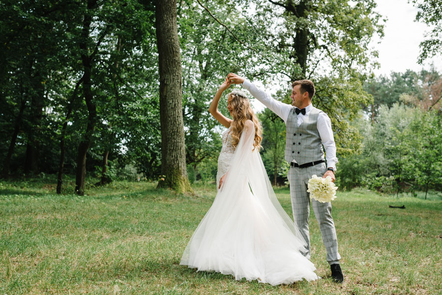 A newly married couple celebrates their wedding day with a joyful dance beneath the trees in a peaceful outdoor setting. Long Island offers a wide variety of scenic wedding locations, from elegant gardens and historic estates to waterfront venues and picturesque parks.
