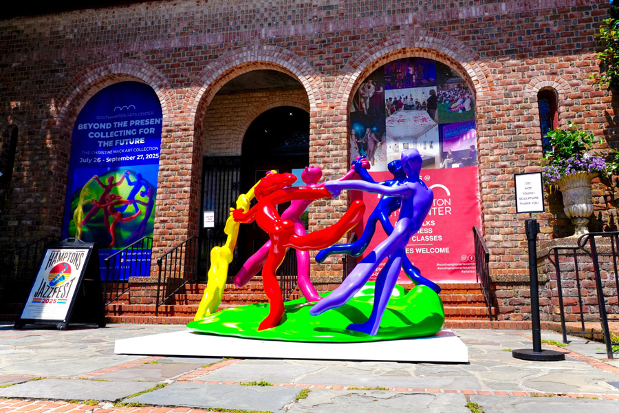 A colorful contemporary sculpture stands outside the Southampton Arts Center on Jobs Lane in Southampton, where rotating exhibitions and cultural programs draw visitors throughout the year. The historic brick building provides a striking backdrop for public art and highlights the East End’s active visual arts scene.
