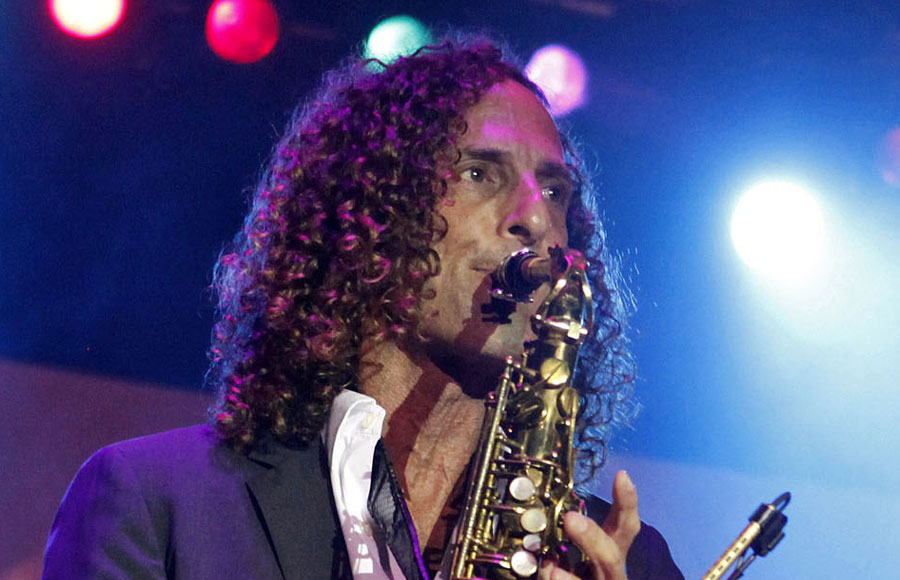 Kenny G performs during a live concert, playing the saxophone for an audience. Known for hits including Songbird and Forever in Love, the Grammy Award-winning musician will perform at Flagstar at Westbury Music Fair on September 26, 2026.