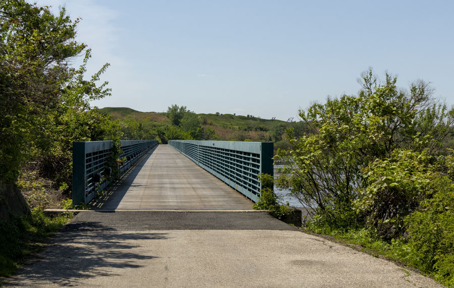 A multi-use trail crosses a pedestrian bridge on Long Island. The planned Long Island Greenway would connect existing trails and new pathways into a nearly 200-mile network stretching from New York City across Nassau and Suffolk counties toward Montauk and Orient Point.