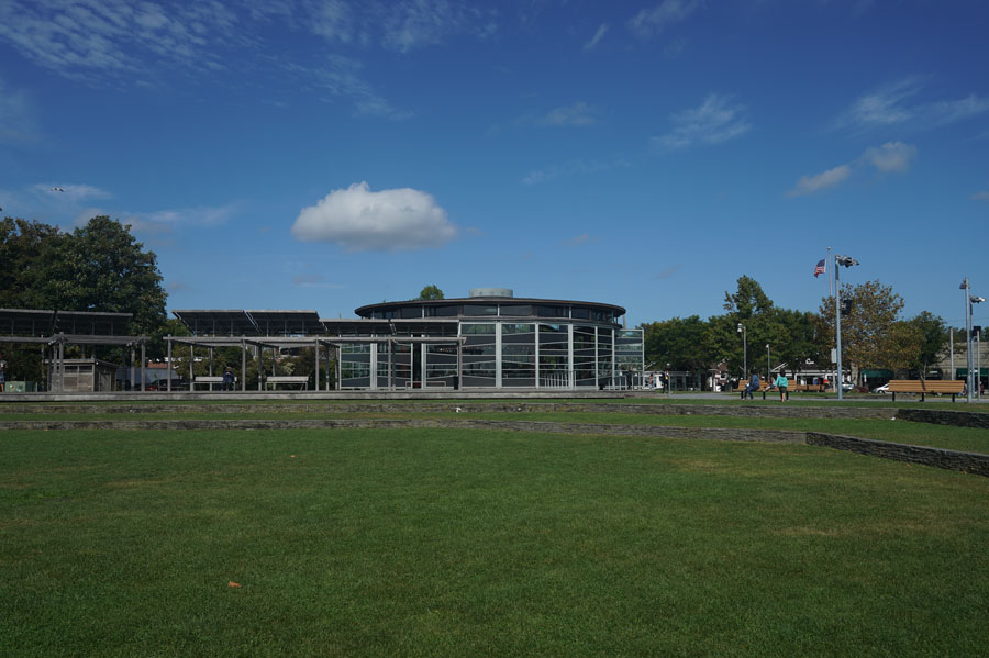 The historic Greenport Carousel sits at the heart of Mitchell Park, where its glass-enclosed pavilion overlooks the park’s expansive lawn and the waterfront in Greenport, Long Island.
