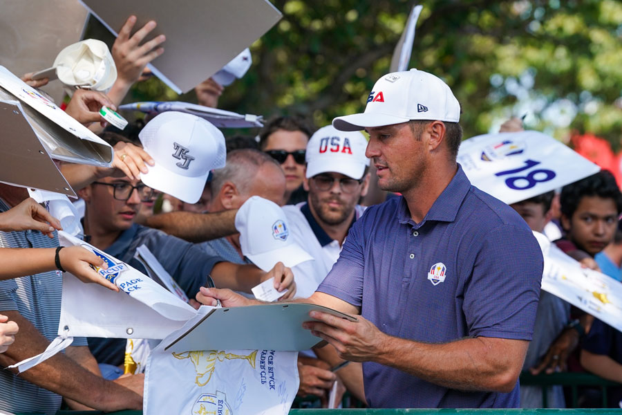 BETHPAGE, NY-SEPT 23: Bryson DeChambeau signs autographs after a practice round on September 23, 2025 at the 45th Ryder Cup at Bethpage State Park Golf Course