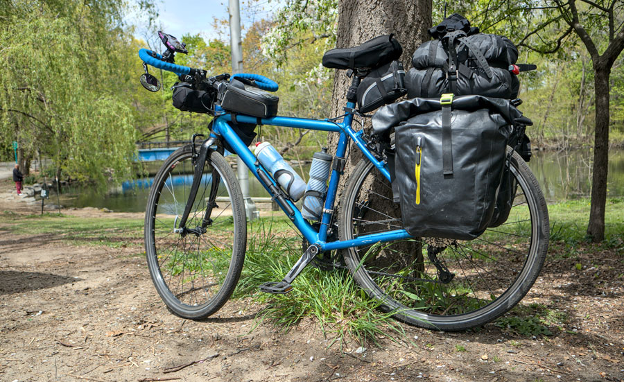 yuriyt A fully loaded touring bicycle equipped with panniers, sleeping gear, water bottles and other supplies rests beside a tree at Van Cortlandt Park in the Bronx, New York City. Bikepacking and bicycle touring combine long-distance cycling with the ability to carry camping gear and other necessities for extended trips. File photo: yuriyt, licensed.