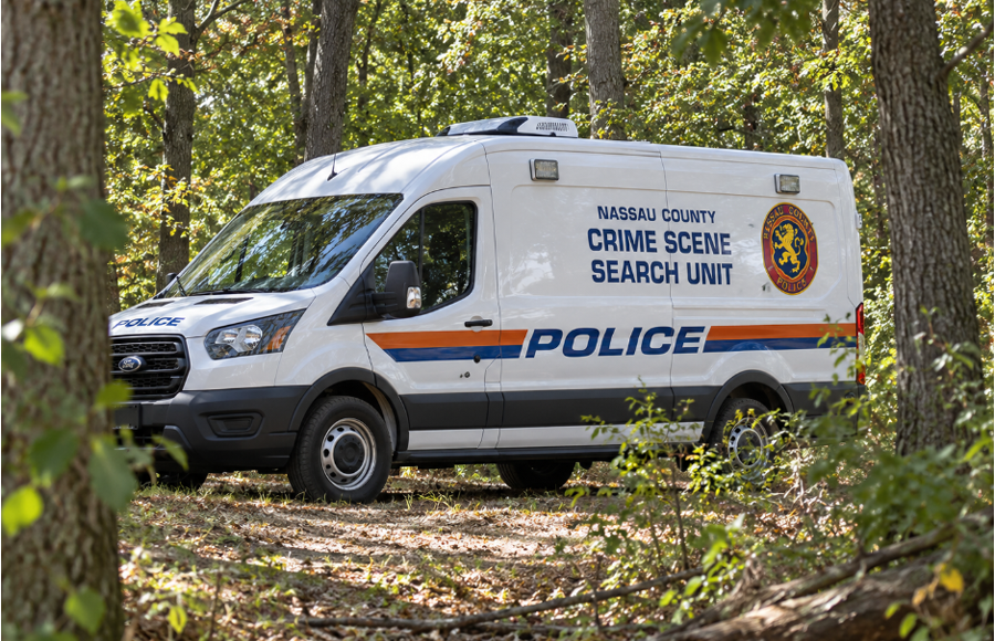 Give me a caption for this photo that'll fit the story. Nassau County police investigators respond to Plandome Pond Park in Manhasset after human skeletal remains were discovered in a wooded area near the Long Island Rail Road tracks. Authorities said the remains were found by high school runners, and the investigation remains ongoing.