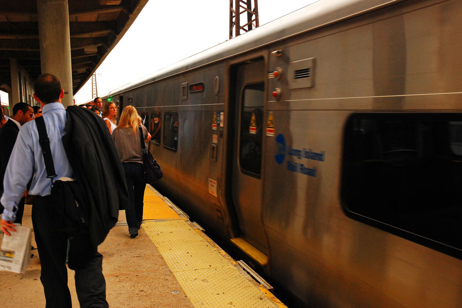 Commuters prepare to board a morning Long Island Rail Road train at Rockville Centre station in this archival photograph. An October 2026 state comptroller report projects LIRR ridership reaching 97% of its 2019 level this year, the strongest recovery among the MTA’s transit and commuter rail services. The forecast comes as the authority faces growing operating budget gaps in later years. File photo: James Kirkikis / Shutterstock.com, licensed.