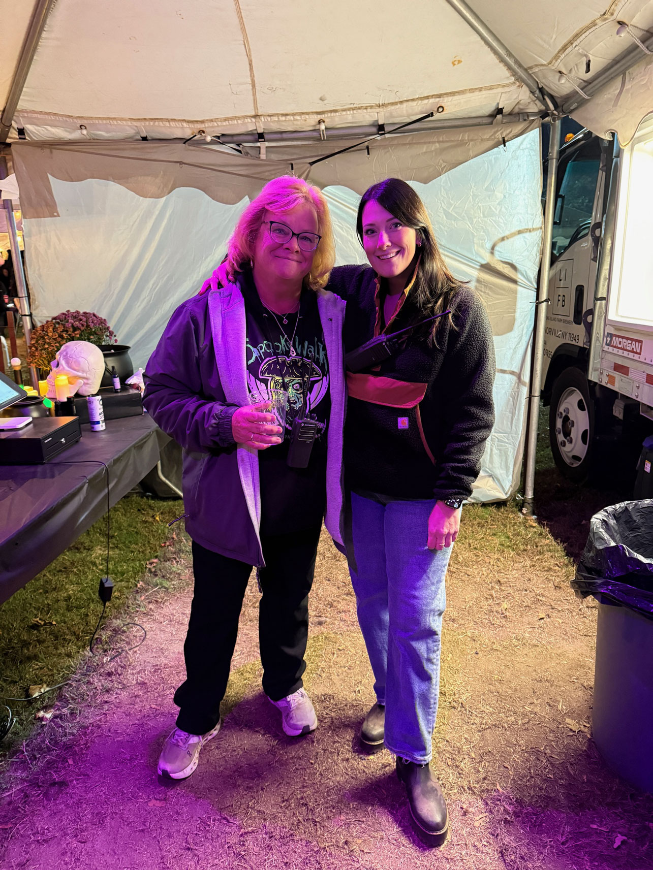 Two participants pose together beneath a tent during Spooky Walk, reflecting the community involvement that has helped sustain the annual fundraiser since 1989. The event is organized, constructed and operated entirely by volunteers, with all proceeds supporting Camp Pa-Qua-Tuck and its programs. Photo courtesy of Camp Pa-Qua-Tuck Fundraisers.